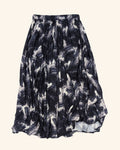 A pleated midi skirt with an abstract brushstroke pattern in navy blue, black. and white, shown against a plain white background.
