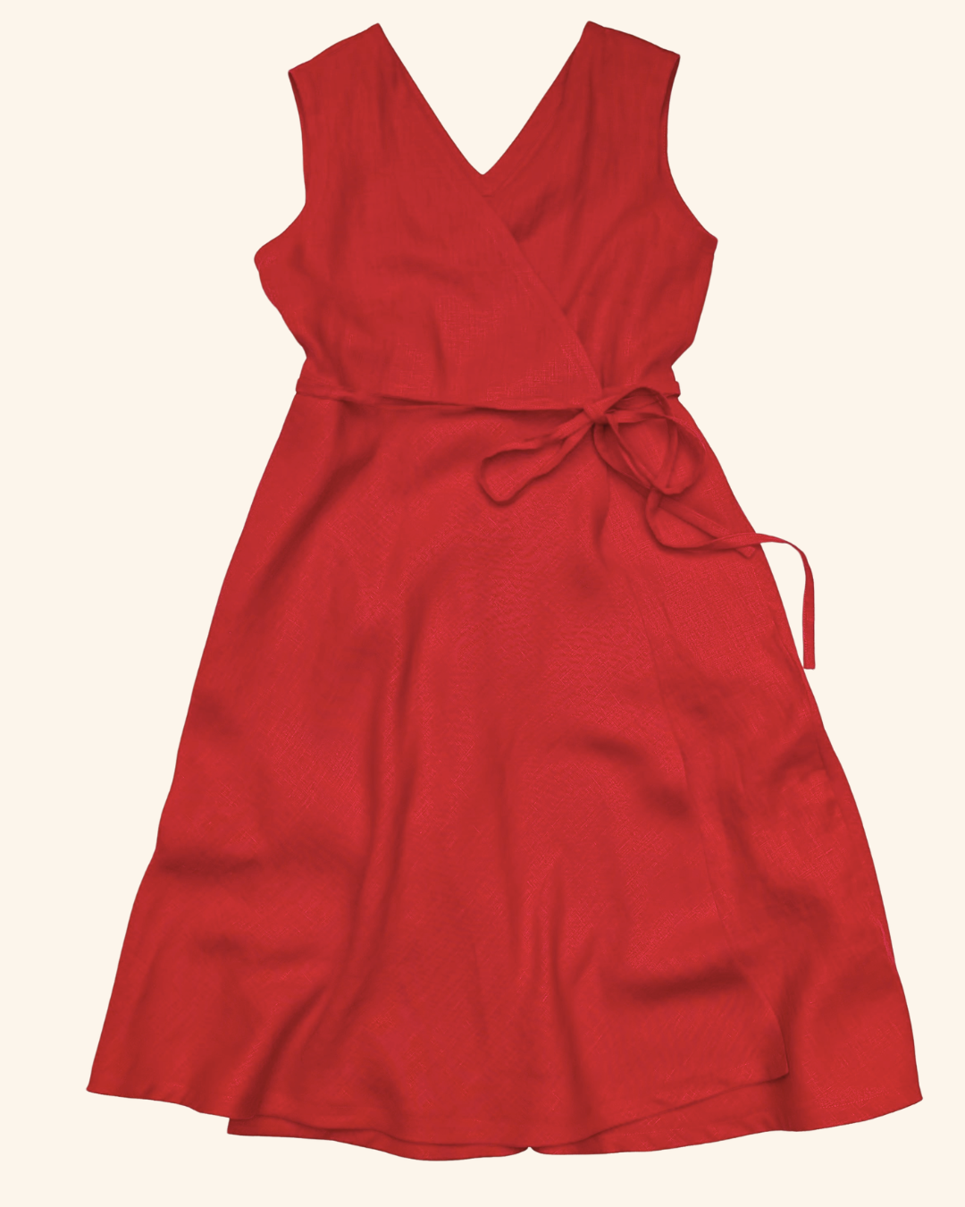 A sleeveless red wrap-style dress with a V-neckline and a self-tie waist belt, shown flat against a light cream background.